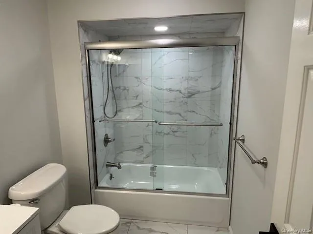a bathroom with a shower a toilet and sink