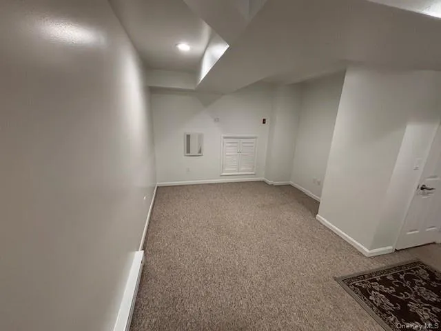 an entryway in a hall with a rug