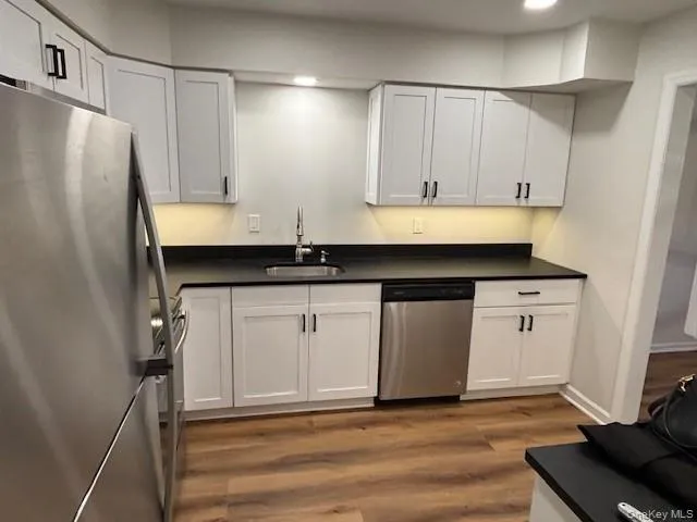 a kitchen with a sink and cabinets