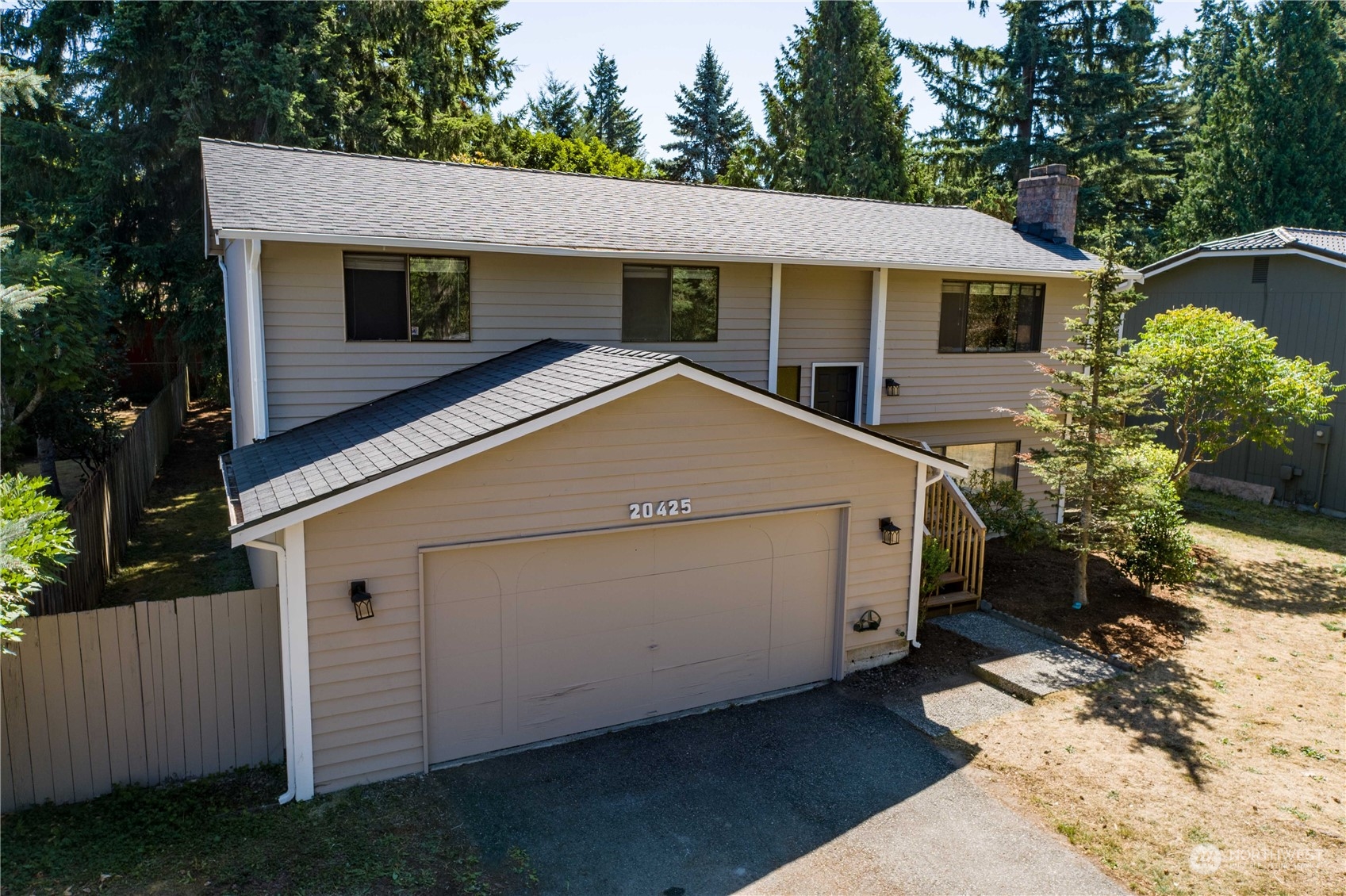 a white house with tree in front of it