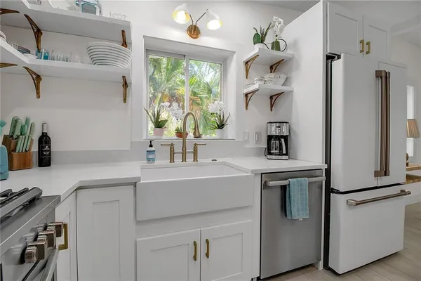 a kitchen with a sink cabinets and window
