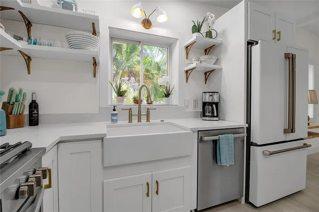 a kitchen with a sink cabinets and window