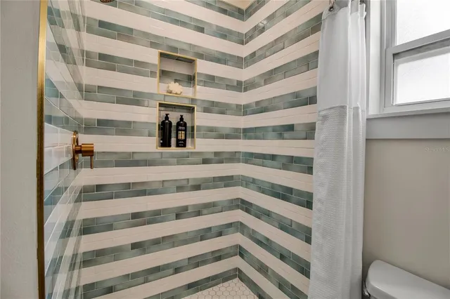 a view of staircase with white walls and a window