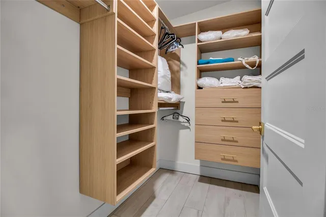 a view of walk in closet with empty racks
