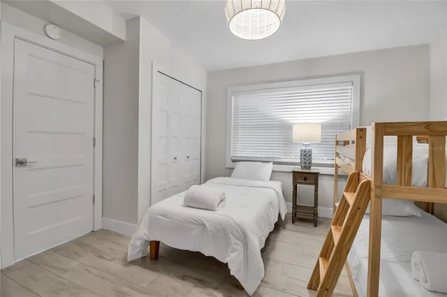 a bedroom with a bed and wooden floor