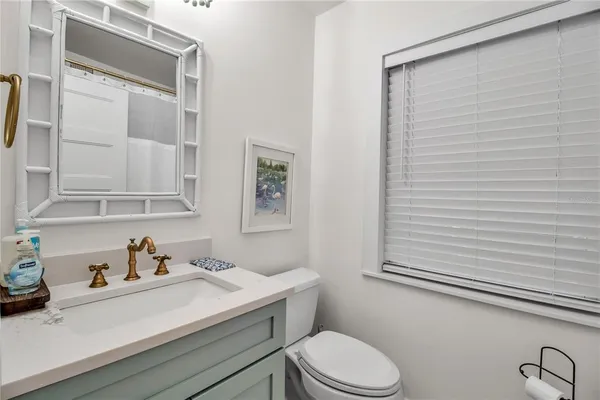 a bathroom with a sink a toilet and vanity