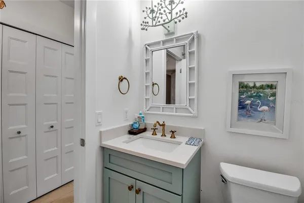 a bathroom with a sink a toilet and mirror
