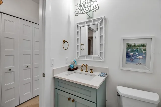 a bathroom with a sink a toilet and mirror