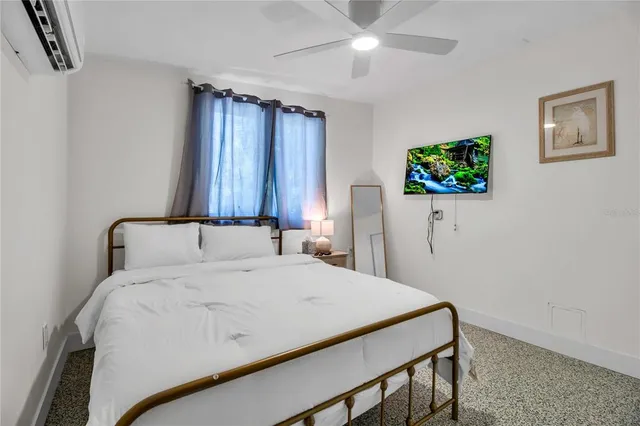 a bedroom with a bed and a flat screen tv