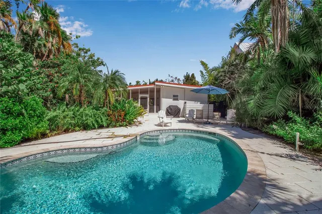 a swimming pool with outdoor seating and yard