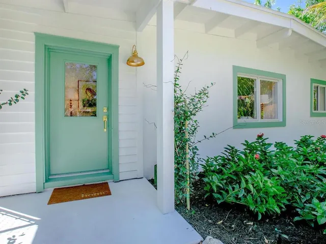 a backyard of a house with potted plants