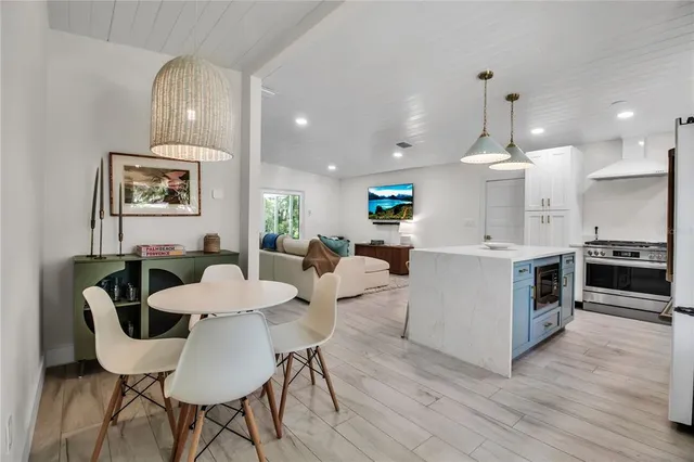 a large kitchen with a table and chairs