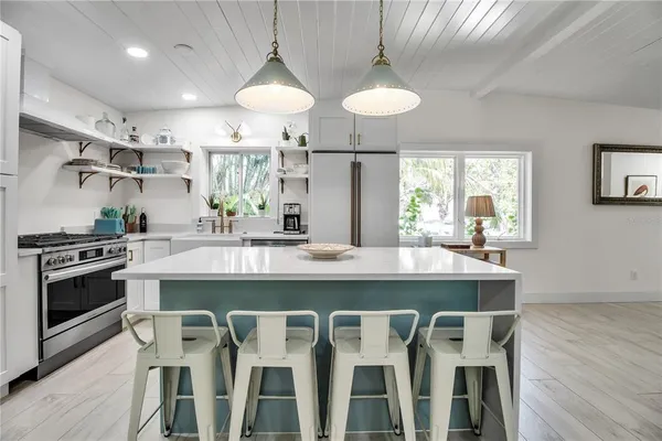 a kitchen with a dining table and chairs