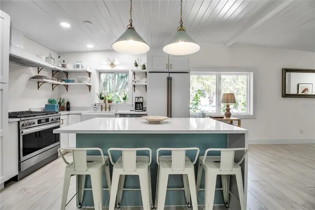 a kitchen with a dining table and chairs