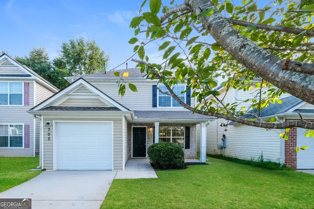 a front view of a house with a yard and garage