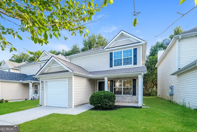 a front view of a house with a yard