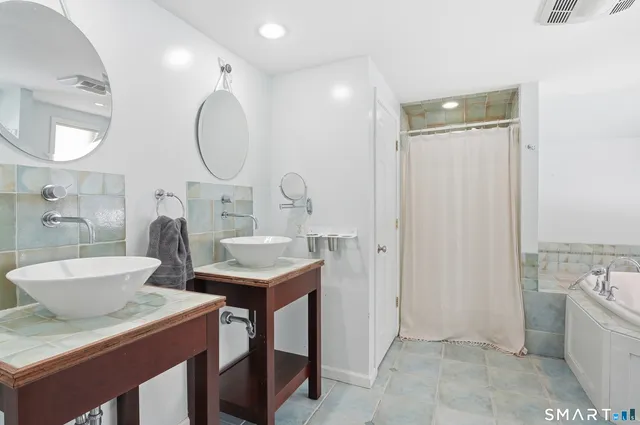 a bathroom with a granite countertop sink mirror and vanity