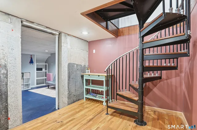 a view of a livingroom with furniture and staircase