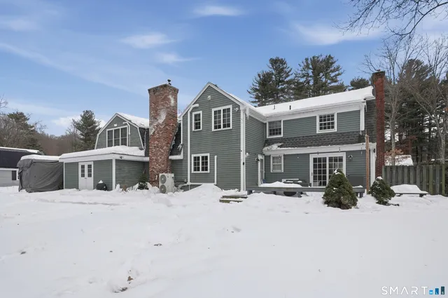 a view of a house with a snow in the background
