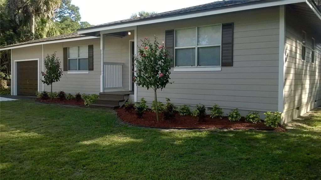 1474 Southwest Del Rio Boulevard Port St. Lucie, FL 34953 - Photo 1 of 9 a view of a house with a backyard