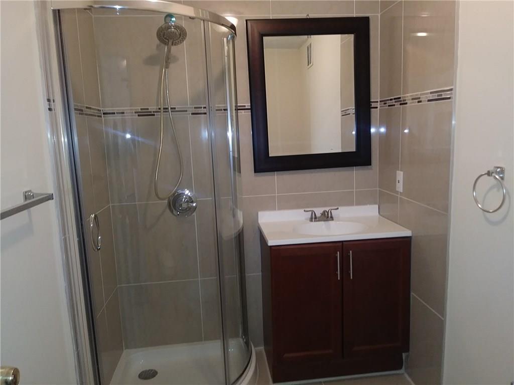 1474 Southwest Del Rio Boulevard Port St. Lucie, FL 34953 - Photo 7 of 9 a bathroom with a sink and mirror