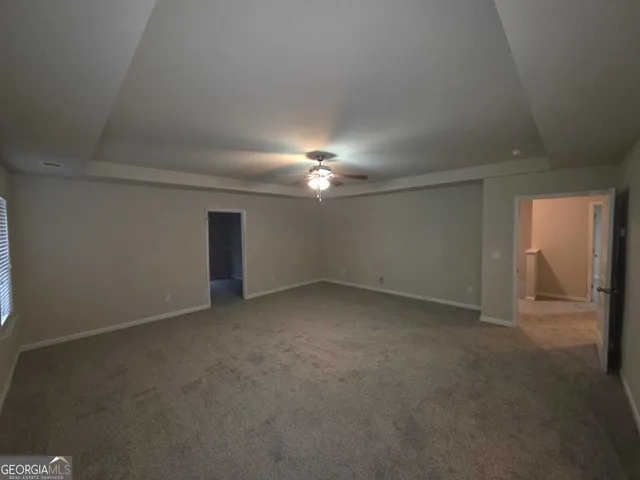 a view of an empty room with a bathroom