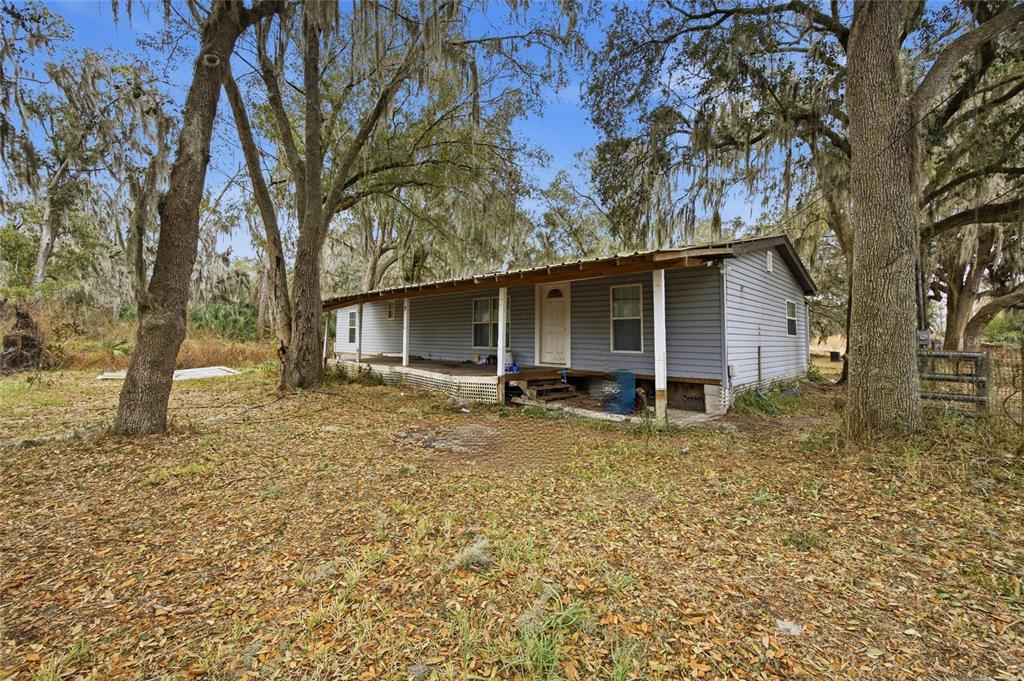 1823 Welcome Road Lithia, FL 33547 - Photo 4 of 17 a backyard of a house with yard and outdoor seating