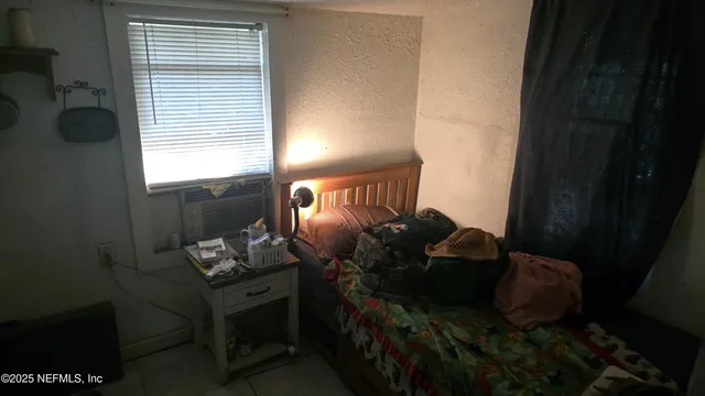 a backyard of a house with table and chairs plants and large tree