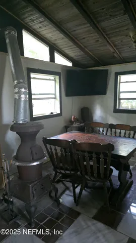 a bedroom with a bed dresser and a window