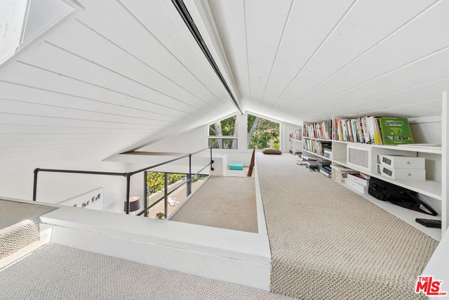 a kitchen with stainless steel appliances a stove and a wooden floor