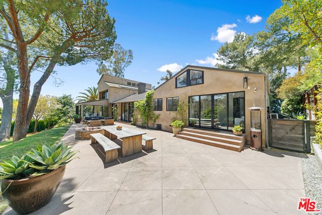 a view of a street with a bench and trees