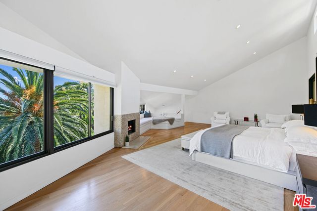 a bathroom with a large tub and window