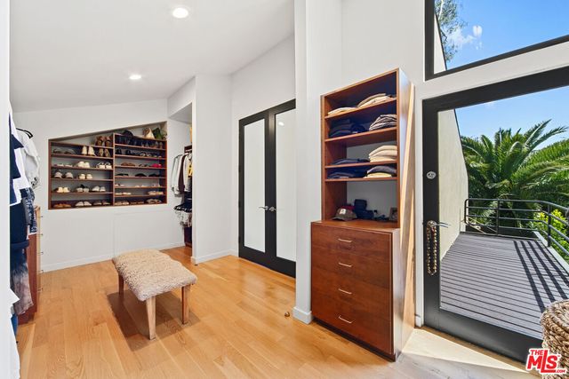 a view of a porch with furniture and wooden floor