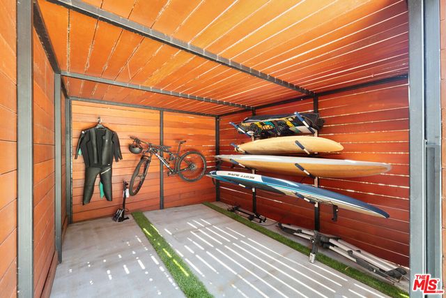 a living room with furniture large wooden floor and a large window