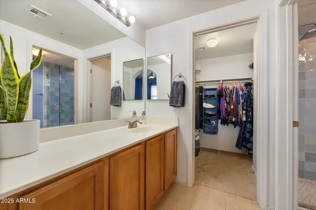 a en suite bathroom with a sink and a mirror