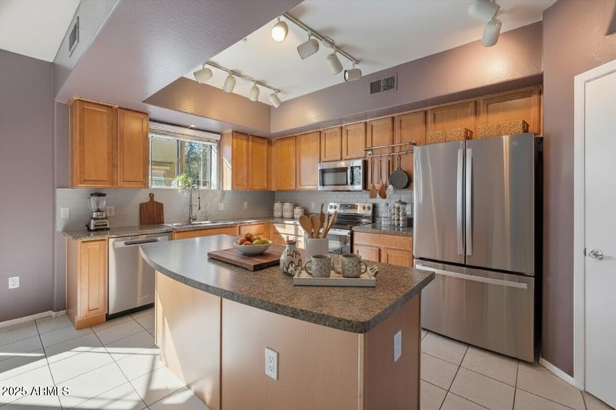 3250 West Greenway Road, Unit 151 Phoenix, AZ 85053 - Photo 2 of 31 a kitchen with refrigerator cabinets and furniture