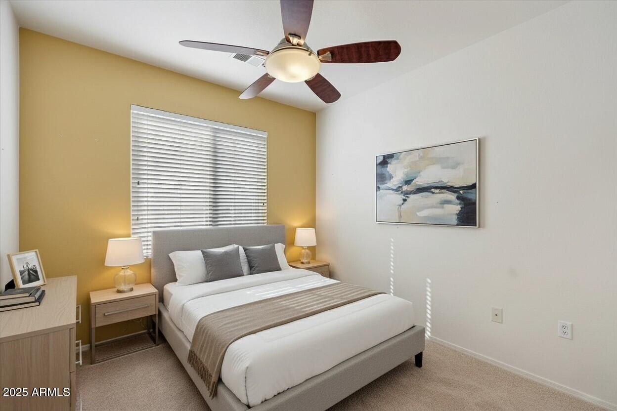 3250 West Greenway Road, Unit 151 Phoenix, AZ 85053 - Photo 22 of 31 a bedroom with a bed and a chandelier