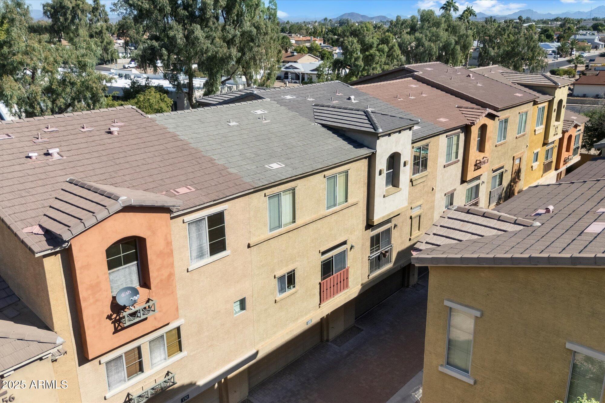 3250 West Greenway Road, Unit 151 Phoenix, AZ 85053 - Photo 28 of 31 an aerial view of multiple houses with a yard