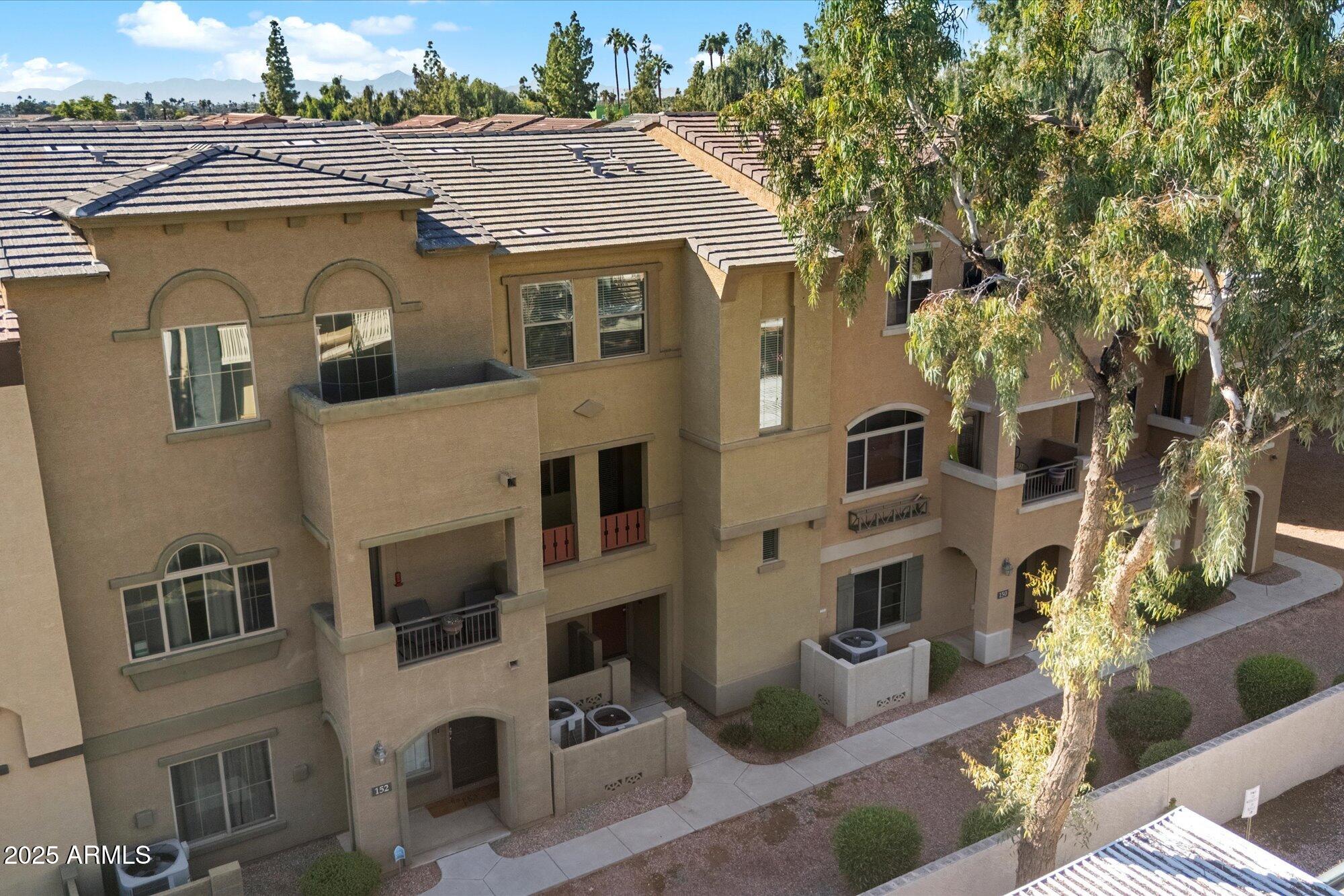3250 West Greenway Road, Unit 151 Phoenix, AZ 85053 - Photo 29 of 31 a view of a big house with many windows