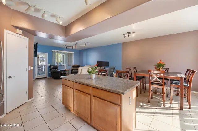 a view of dining table chairs and kitchen view