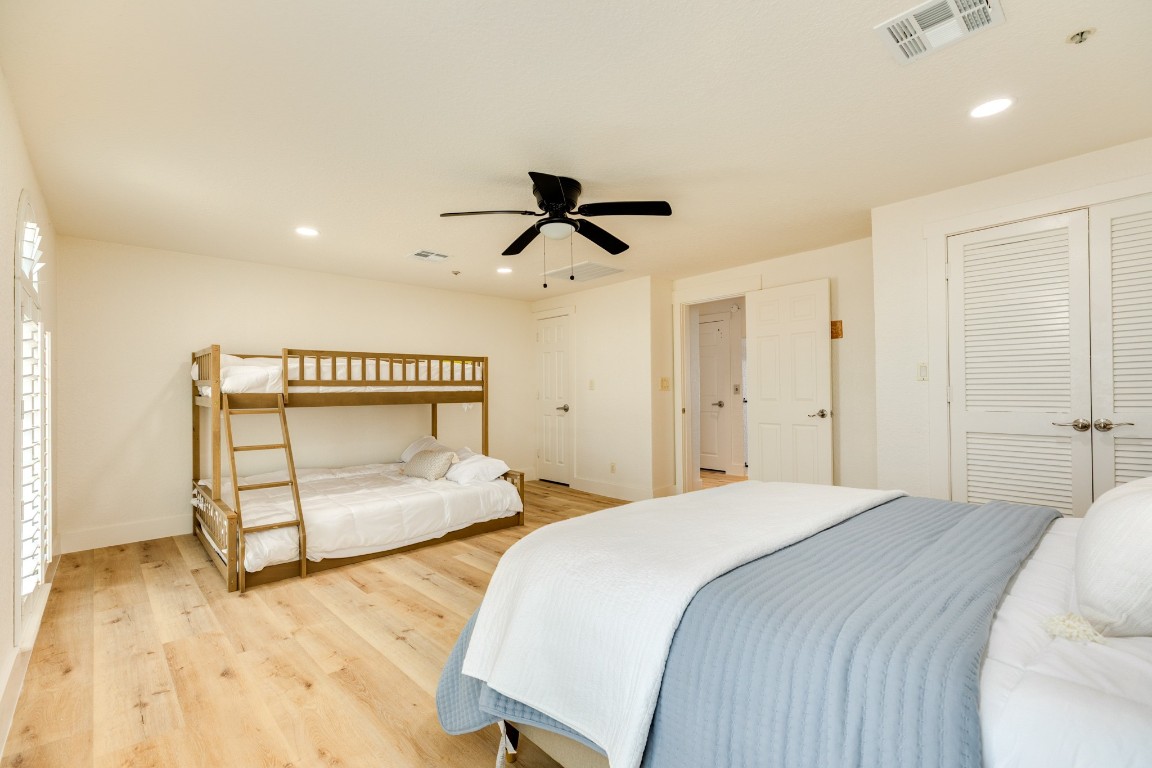 411 Sailfish Lane, Unit 101 Freeport, TX 77541 - Photo 21 of 40 a bedroom with a bed and a ceiling fan