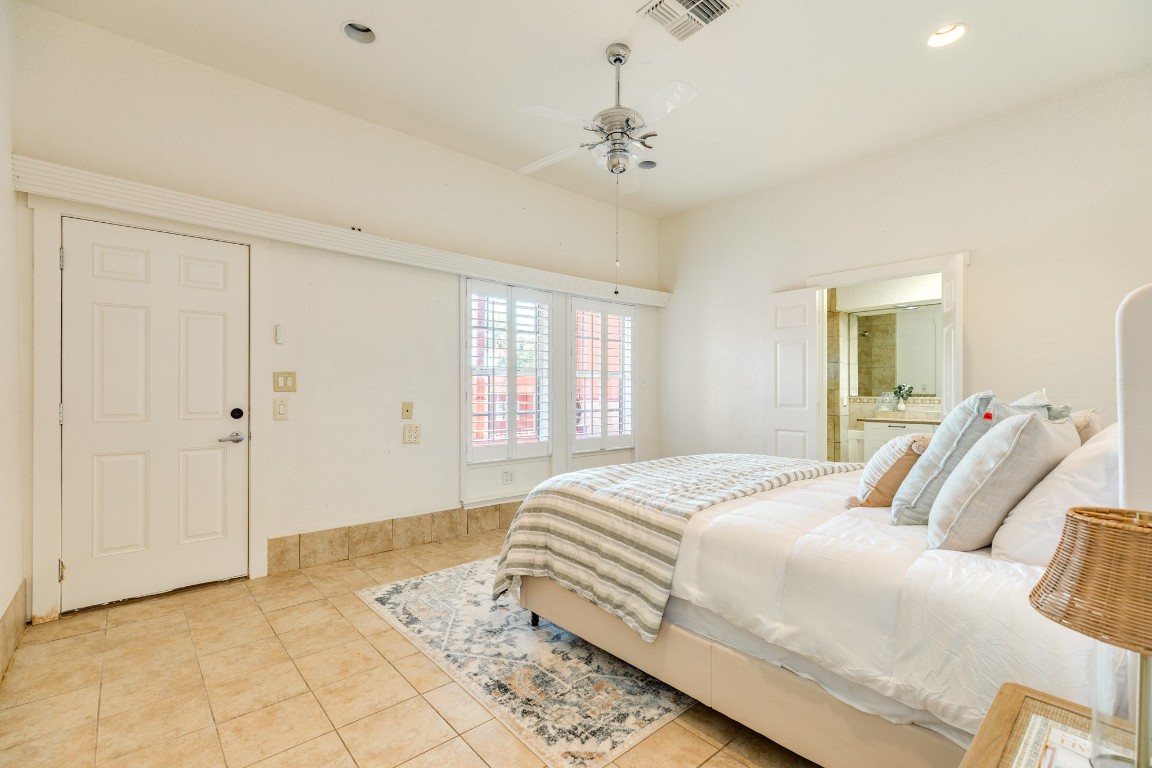 411 Sailfish Lane, Unit 101 Freeport, TX 77541 - Photo 23 of 40 a bedroom with a bed and a chandelier
