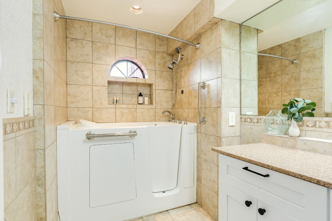 411 Sailfish Lane, Unit 101 Freeport, TX 77541 - Photo 26 of 40 a bathroom with a sink a mirror and a shower