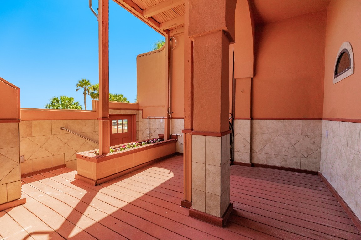 411 Sailfish Lane, Unit 101 Freeport, TX 77541 - Photo 34 of 40 a view of a balcony with wooden floor and bench