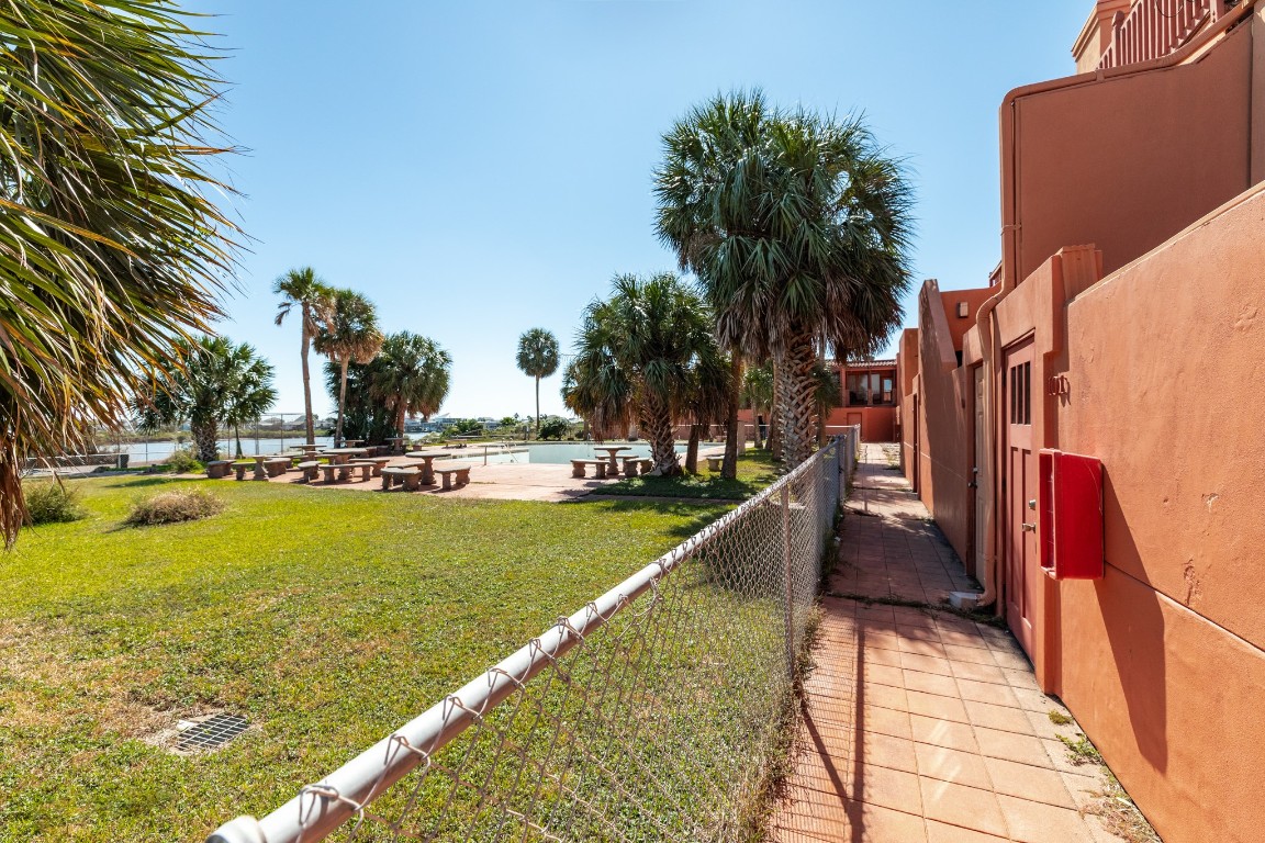 411 Sailfish Lane, Unit 101 Freeport, TX 77541 - Photo 40 of 40 a view of swimming pool with outdoor seating and trees