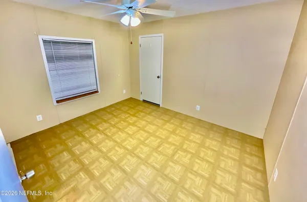a view of an empty room with a window