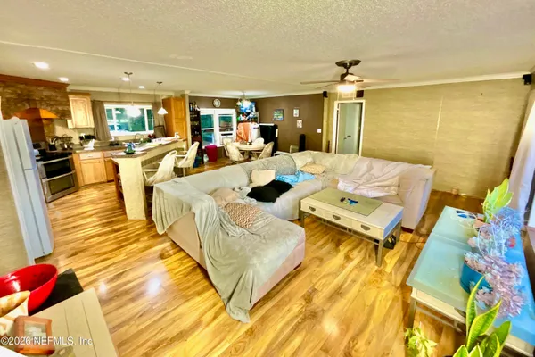 a living room with couches and kitchen view