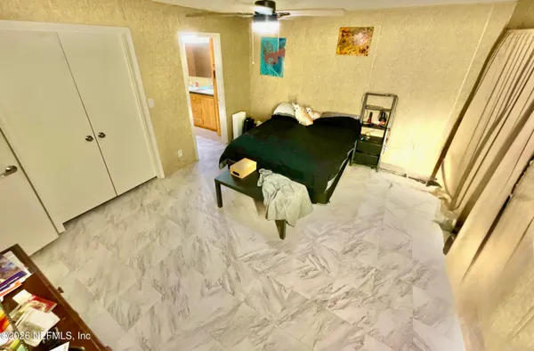 a bedroom with a bed and a mirror