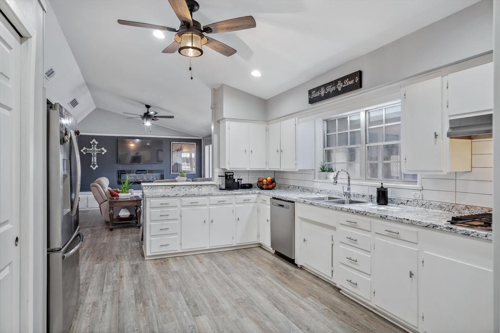 103 Brandon Street Edgewood, TX 75117 - Photo 15 of 29 a kitchen with a sink cabinets stainless steel appliances and a window