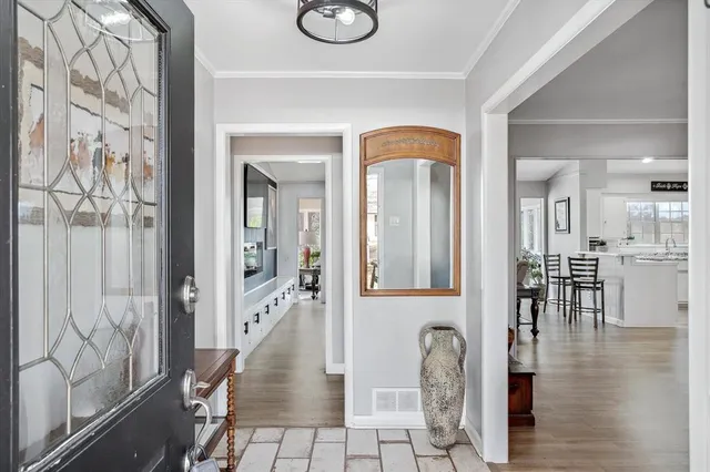 a view of living room and kitchen with wooden floor